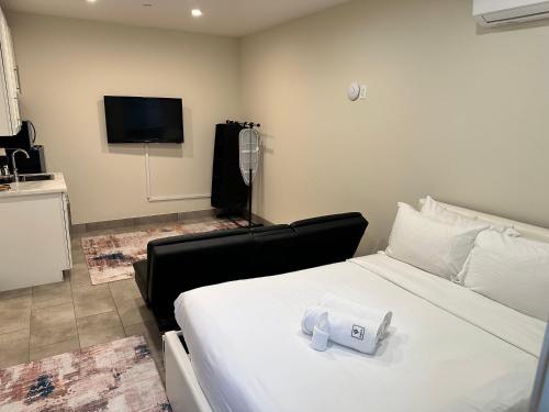 a hotel room with a bed with a towel on it at Studio with Private Entrance next to Balboa Park in San Diego