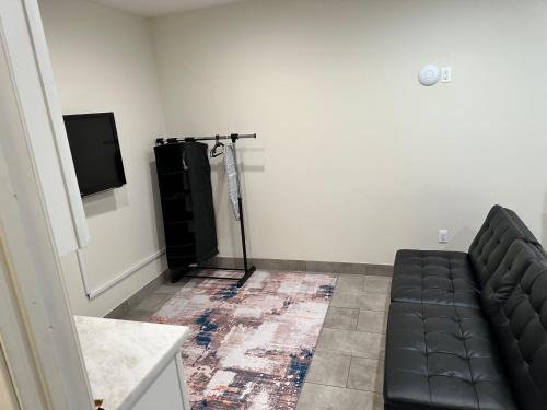 a living room with a couch and a flat screen tv at Studio with Private Entrance next to Balboa Park in San Diego
