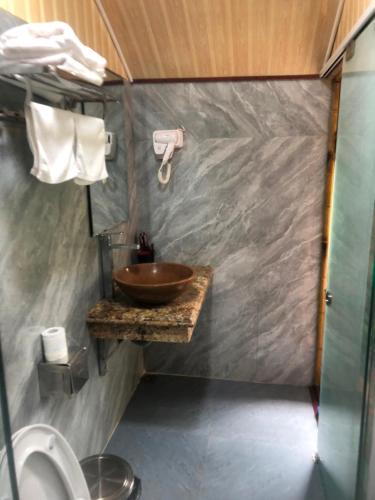 a small bathroom with a sink and a toilet at Xuan Son Lakeside Bungalow in Ninh Binh