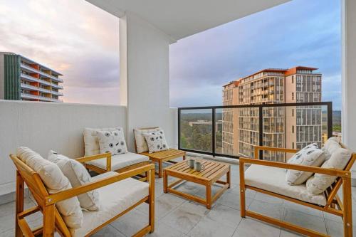 a living room with white furniture and a large window at Brand new 2BD Modern Apt near MQ shopping centre in Sydney