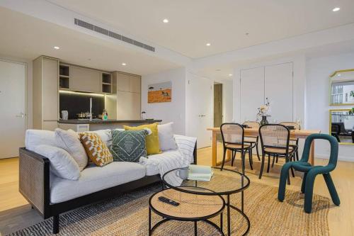 a living room with a couch and a table at Brand new 2BD Modern Apt near MQ shopping centre in Sydney