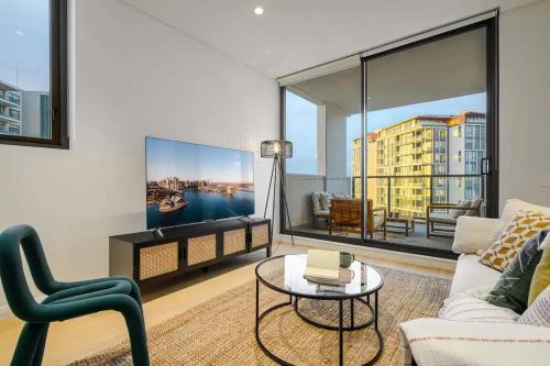 a living room with a couch and a table at Brand new 2BD Modern Apt near MQ shopping centre in Sydney