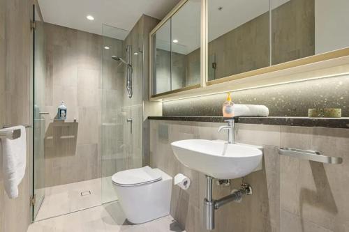 a bathroom with a sink and a toilet and a shower at Brand new 2BD Modern Apt near MQ shopping centre in Sydney