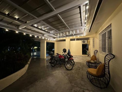 a motorcycle parked inside of a building with chairs at Clark stay in Fort Stotsenburg