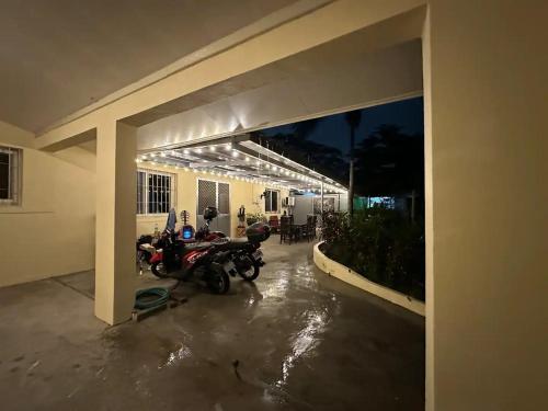 a motorcycle parked in a garage at night at Clark stay in Fort Stotsenburg