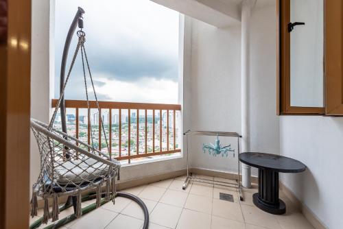 a room with a swing and a table and a window at Resort Suites Pyramid & Lagoon in Petaling Jaya