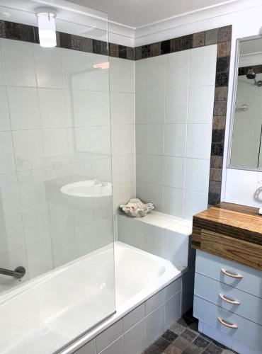 a bathroom with a tub and a sink at Points North Apartments in Gold Coast
