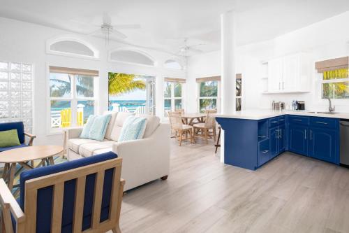 a kitchen and living room with blue cabinets at The Ambergris Grand in San Pedro