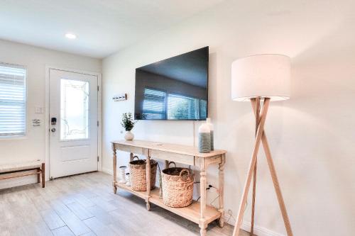 a room with a table with a lamp and a mirror at Beachside Bliss Spacious 3BR Retreat, Steps to Ocean in Oceanside