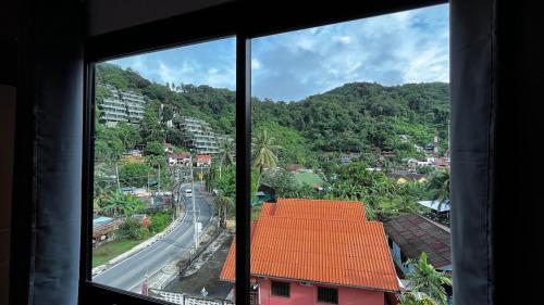 a view from a window of a town with a road at Coco Mountain View Guest House Hotel in Kata Beach