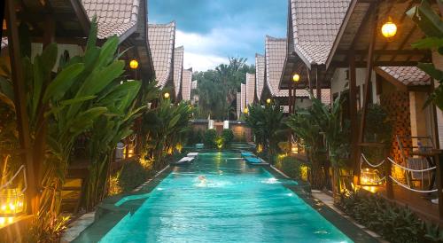 a swimming pool in the middle of a building at Kaleydo Villas in Gili Trawangan