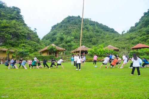 a group of people playing soccer in a field at Nasan Green Farm in Cao Bằng
