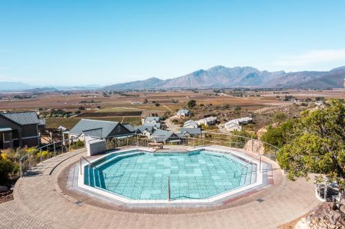 an overhead view of a swimming pool with mountains in the background at ATKV Goudini Spa in Rawsonville