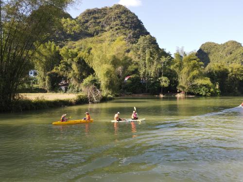 a group of people in kayaks on a river at Nasan Green Farm in Cao Bằng