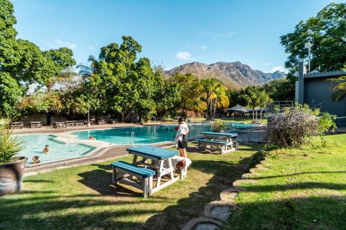a person standing next to a pool at a resort at ATKV Goudini Spa in Rawsonville