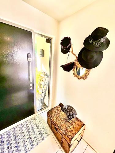 a room with a door and a hat on the wall at Sea views in luxury at LYTTELTON BOATIQUE HOUSE - 14 km from Christchurch in  Lyttelton
