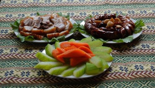 three plates filled with different types of food on a table at Nasan Green Farm in Cao Bằng