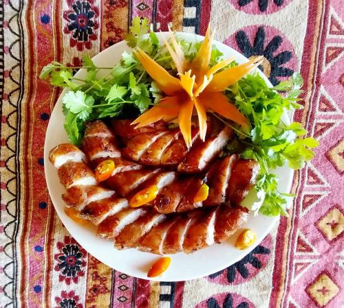 a plate of food with sausages and a salad at Nasan Green Farm in Cao Bằng