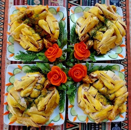 three plates of food with flowers on a table at Nasan Green Farm in Cao Bằng