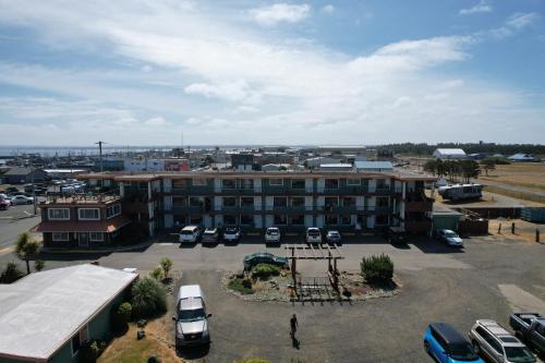 a large building with cars parked in a parking lot at Westport Inn in Westport