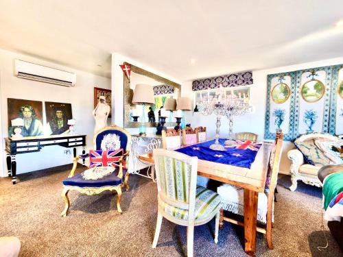 a room with a table and chairs and a bedroom at Sea views in luxury at LYTTELTON BOATIQUE HOUSE - 14 km from Christchurch in  Lyttelton