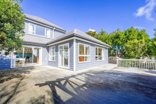 a large white house with a large patio at Three-Bedroom Home in Somerville in Auckland