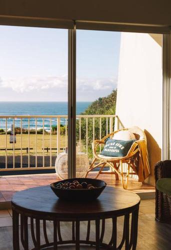 a room with a table and a view of the ocean at Ocean View Pippi Beach Yamba in Yamba