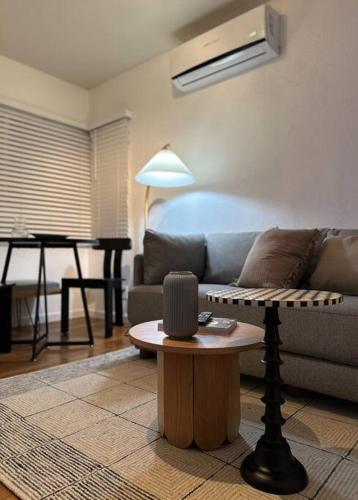 a living room with a couch and a table at Modern Eclectic 1BR by Downtown, Airport & More in San Diego