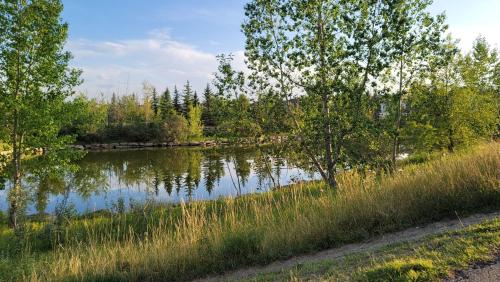 a body of water with trees in the background at The King place, is a ROOM in a PRIVATE HOUSE, close to CTrain and Spruce Meadows Equestrian in Calgary