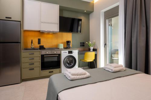 a kitchen with a washing machine and a washer at Mosaic Urban Living in Heraklio Town