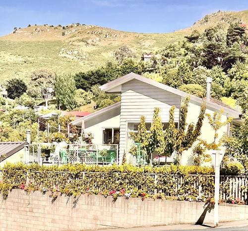 a house with a cactus in front of it at Sea views in luxury at LYTTELTON BOATIQUE HOUSE - 14 km from Christchurch in  Lyttelton