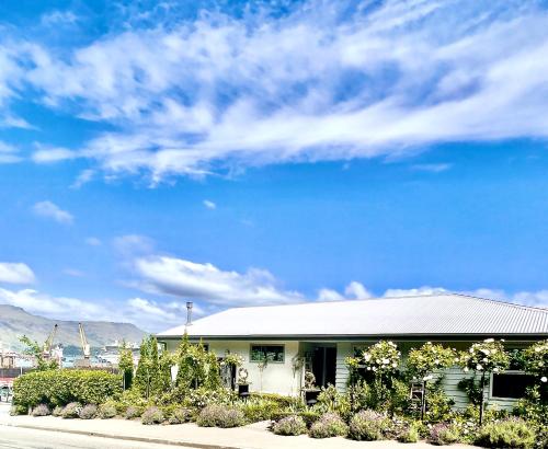 a building with a blue sky in the background at Sea views in luxury at LYTTELTON BOATIQUE HOUSE - 14 km from Christchurch in  Lyttelton