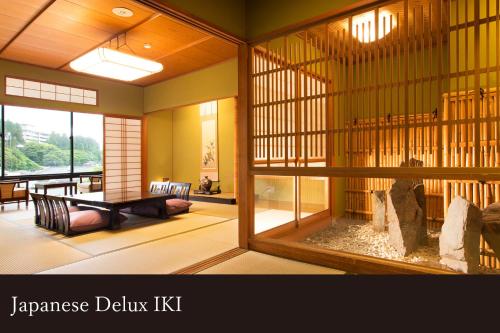 a japanese delta kit room with a table and a room with a table at Yamanaka Onsen Kissho Yamanaka in Kaga