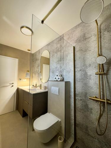 a bathroom with a toilet and a sink and a shower at Beachfront Holiday Home Prora Mare with Sea View in Ždrelac