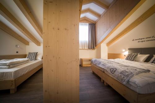 Postel nebo postele na pokoji v ubytování Aparthotel Dolomites Living&Relax