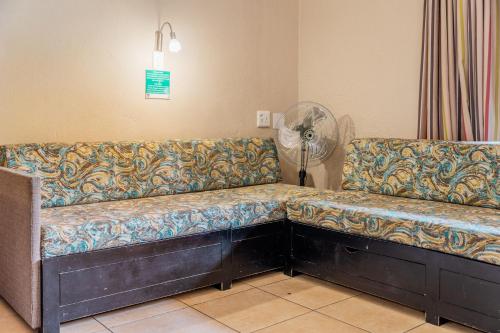 two couches sitting in a room with a fan at ATKV Goudini Spa in Rawsonville