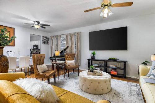 a living room with a couch and a flat screen tv at RARE FIND! Heatd Pool Spa GameRoom Fall Special! in San Antonio