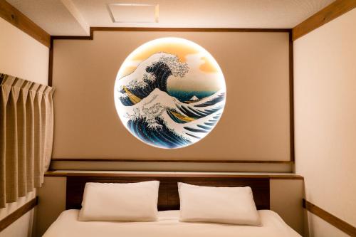 a room with a painting of the great wave at 都電屋 TodenHotel in Tokyo
