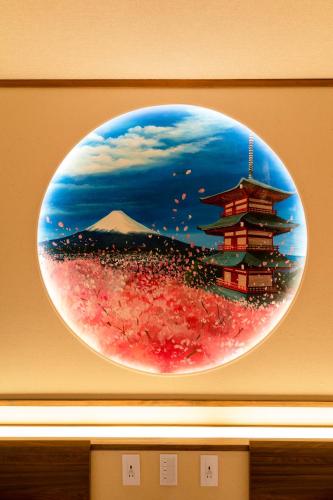 a painting of a building on a wall at 都電屋 TodenHotel in Tokyo