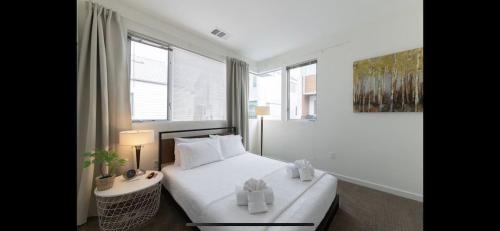 a bedroom with a bed with two boxes on it at Costa Mesa Cozy Retreat, Modern and Smart Home in Costa Mesa