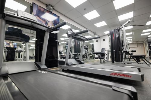 a gym with a treadmill and chairs in it at Grand Court Hotel in Jerusalem