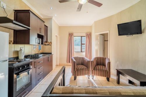 a kitchen with two chairs and a table at ATKV Goudini Spa in Rawsonville