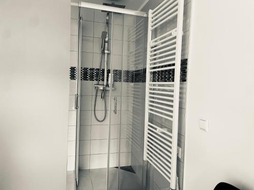 a shower in a bathroom with white tiles at BRIGHT SINGLE ROOM IN GUEST House in Luxembourg