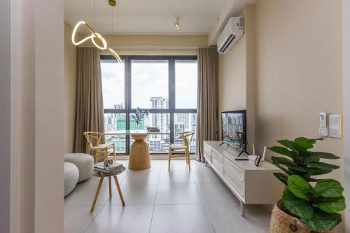 a living room with a couch and a tv at Designer Suites 2BR Apartment in Penang near George Town Self Check-In WiFi Partial Seaview in Jelutong