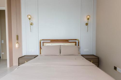 a bed with two white pillows in a room at Designer Suites 2BR Apartment in Penang near George Town Self Check-In WiFi Partial Seaview in Jelutong