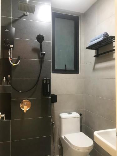 a bathroom with a shower with a toilet and a sink at Designer Suites 2BR Apartment in Penang near George Town Self Check-In WiFi Partial Seaview in Jelutong