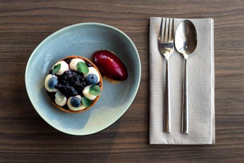 a plate with a dessert on a table next to a fork at Enter St Elisabeth Suites & Spa in Tromsø
