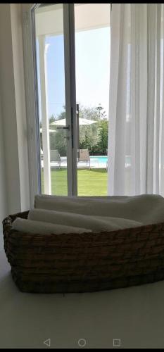 a wicker basket sitting in front of a window at Relais Villa Ottavia in Bitonto