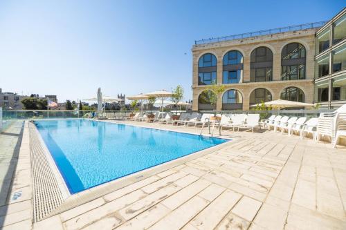 a swimming pool in front of a building at Grand Court Hotel in Jerusalem