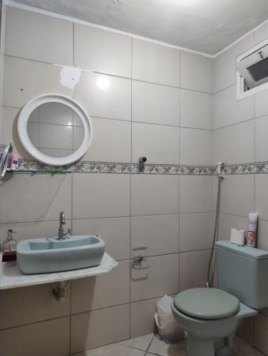 a bathroom with a sink and a toilet and a mirror at Centro de Convenções - Hospedagem in Recife